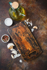 Cutting board, with spices, thyme, garlic, olive oil, salt, pepper and Wooden board.