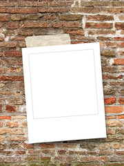 Blank square instant photo frame on old weathered brick wall background