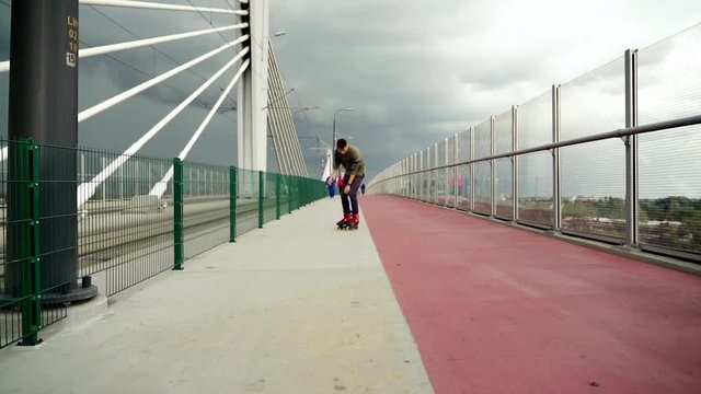 Young man in rollerblades riding in the city, super slow motion
