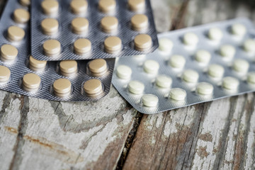 Medicine pills in packs. Pills in blister pack,Capsules and pill packed in blisters on white wooden...