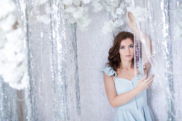 Beautiful young woman in silver studio