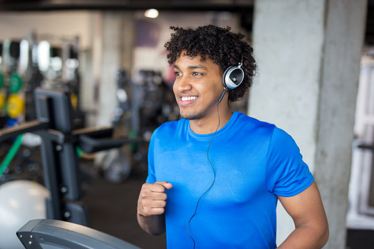 Handsome African American Man Working Out At The Gym While Listening To Music