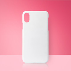White mobile cover on pink backdrops. Blank phone case for printing.