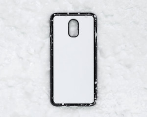 Black mobile cover on snow texture background. Phone case and white surface for printing.
