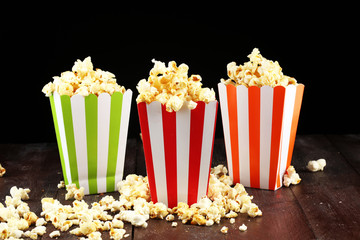 Cinema concept with popcorn in green white bag.
