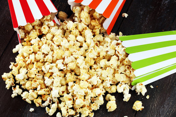 Cinema concept with popcorn in green white bag.