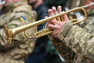 Musician of military orchestra of the Ukrainian army plays the trumpet, the Armed Forces of Ukraine