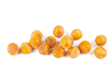 Pile of half-dried yellow cherry plums isolated on the white background