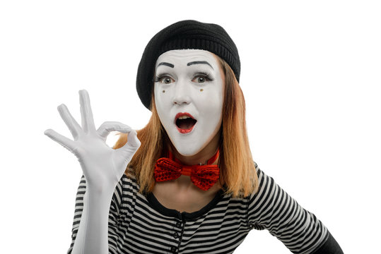 Female mime showing OK sign