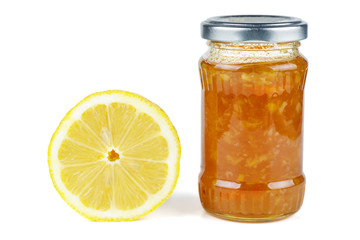 Half of lemon and Homemade jam in glass jar isolated on white background