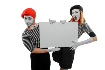 Two mimes holding big board