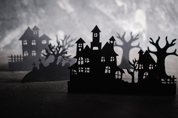 Halloween night background. Paper art. Abandoned village in a dark misty forest