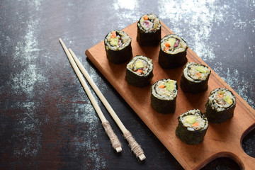 Sushi from cauliflower, avocado, tuna and carrots. Traditional Asian food. Diet healthy food concept. Cereals free. Gluten free. Dairy free. AIP Autoimmune Paleo. Copy space for text.