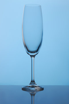 Long stem crystal champagne flutes. Blue lighting.