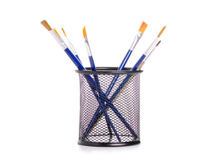 Paint brushes in a glass on a white background. Isolation