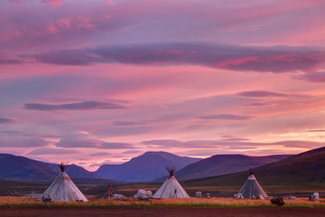 Morning landscape with dwellings of nomadic reindeer herders at sunrise. Russia