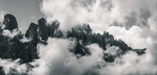 The Dolomites mountain tops covered in Clouds