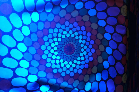 Spinning RGB colored hallucination on a wall