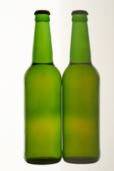 Two green beer bottles. White isolated background.