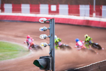 Speedway race, focus on the traffic light on foreground