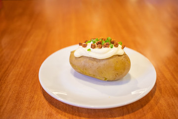 Steamed potato with sour white cream on top