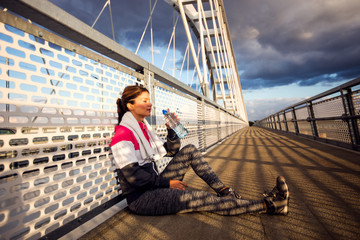 Fitness woman take a rest after jogging,drinking water