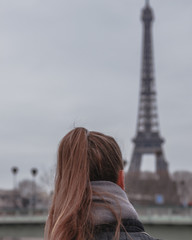 woman in paris looking at view of eiffel tower