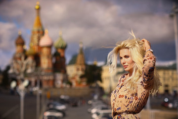 blond fashion model russian girl close up photo on red square background