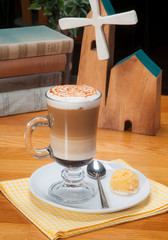 caffe mocha with whipped cream in the irish glass. with cookie on the wooden table