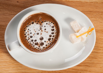 a cup of turkish coffee with heart shape top view