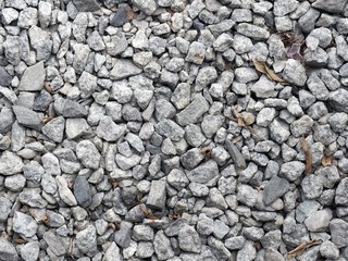 Crushed grey stone on the ground texture background