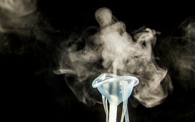 Steam mist from Nebulizer or nebuliser electrical machine drug delivery device used to administer medication in the form of a mist inhaled into the lungs concept. 