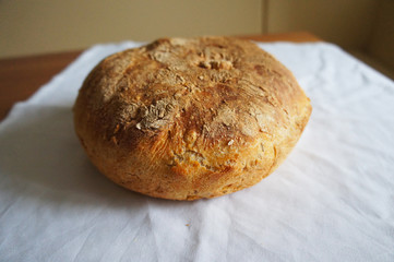 Round bread on white tablecloth
