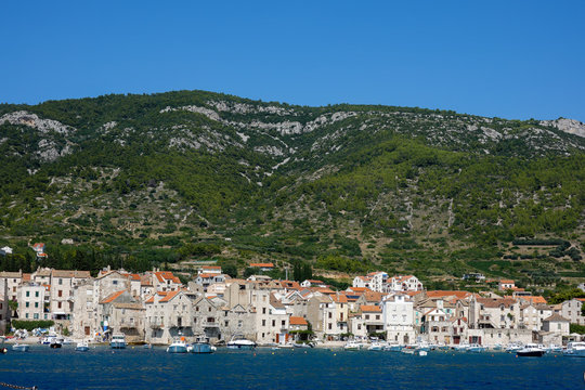 Komiza, Croatia, July 27, 2018: Komiza, a Croatian town with 17th and 18th century stone town houses, on the western coast of the island of Vis, at the foot of the Hum hill.