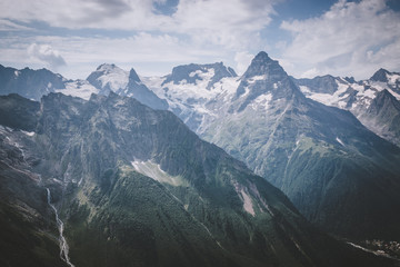 Closeup view mountains scenes in national park Dombai, Caucasus, Russia, Europe. Summer landscape, sunshine weather, dramatic blue sky and sunny day