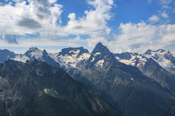 Closeup view mountains scenes in national park Dombai, Caucasus, Russia, Europe. Summer landscape, sunshine weather, dramatic blue sky and sunny day