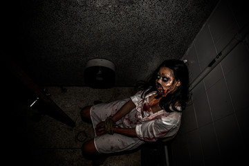 Portrait of asian woman make up ghost face with blood,Horror scene,Scary background,Halloween...