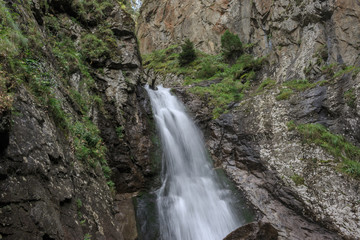 Fototapeta na wymiar Closeup view waterfall scenes in mountains, national park Dombai, Caucasus, Russia, Europe. Summer landscape, sunshine weather and sunny day