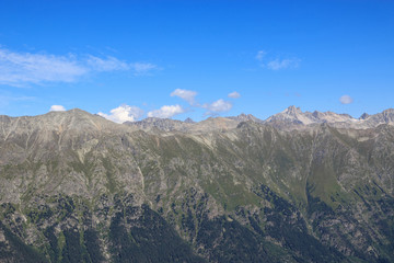 Closeup view mountains scenes in national park Dombai, Caucasus, Russia, Europe. Summer landscape, sunshine weather, dramatic blue sky and sunny day