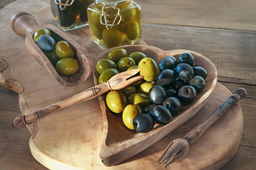 green olives are on the table in a bowl of olive tree. The concept of healthy eating