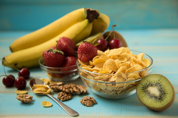 Tasty cornflakes witt walnut in glass bowl