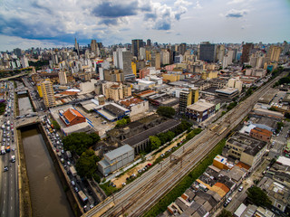 Fototapeta na wymiar Great cities, great avenues, houses and buildings. Light district (Bairro da Luz), Sao Paulo Brazil, South America. Rail and subway trains. Aerial view of State Avenue next to the Tamanduatei River 