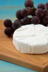 camembert, with a fork for cheese and grape