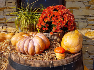 Pumpkins on a wooden barrel.