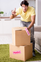 Man moving house and relocating with fragile items