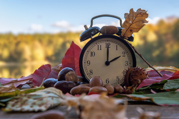 Time change in the autumn in the winter time. Alarm clock switches to winter time. Changing the...