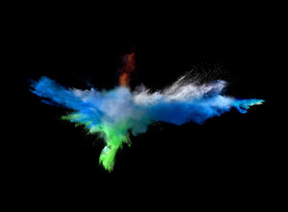 Fantastic forms of powder paint and flour combined  together explode in front of a black background...