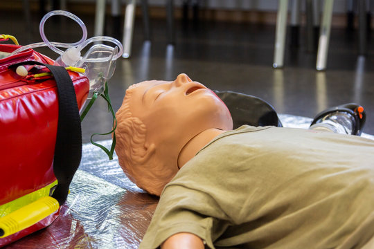 Medical teenager puppet lies injured on the ground