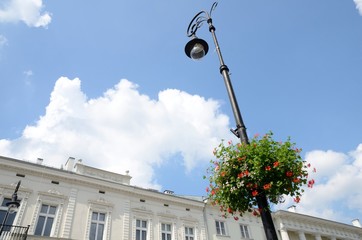 Red flowers on street lamp in Warsaw, Poland.