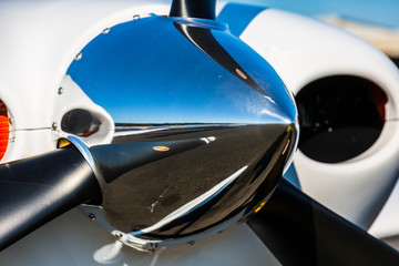 A close up of the spinner on the tip of the propeller of a single engine piston aircraft.  